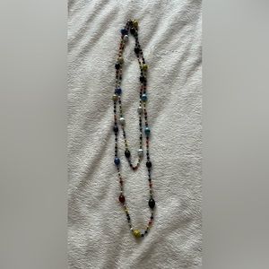 Unique beaded necklace 26”. Lots of colored beads with a chain link.